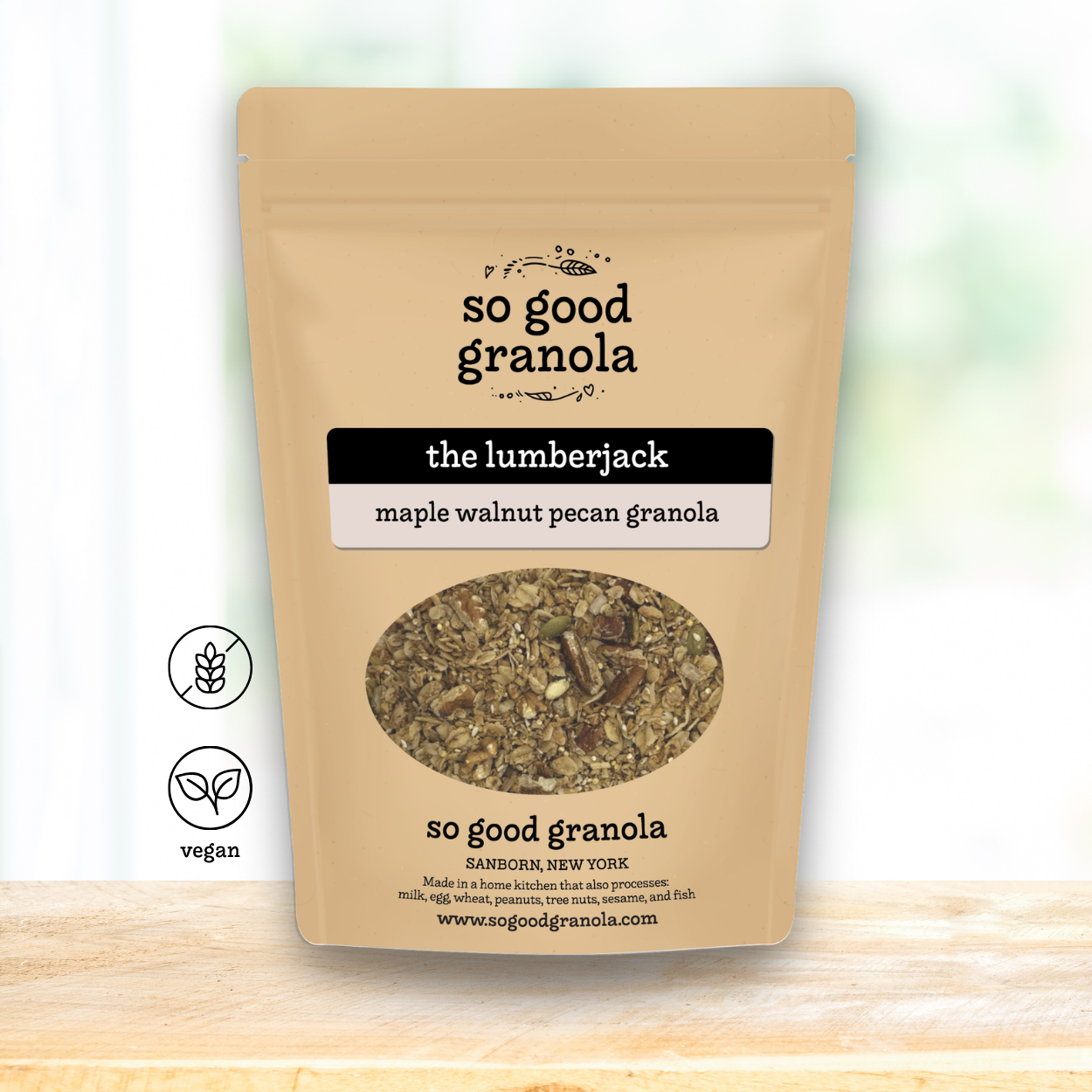 Kraft paper packaging of 'so good granola' with a label for 'the lumberjack' flavor on a light background.