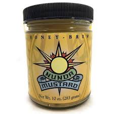 Jar of Nundu Mustard with a black lid on a white background