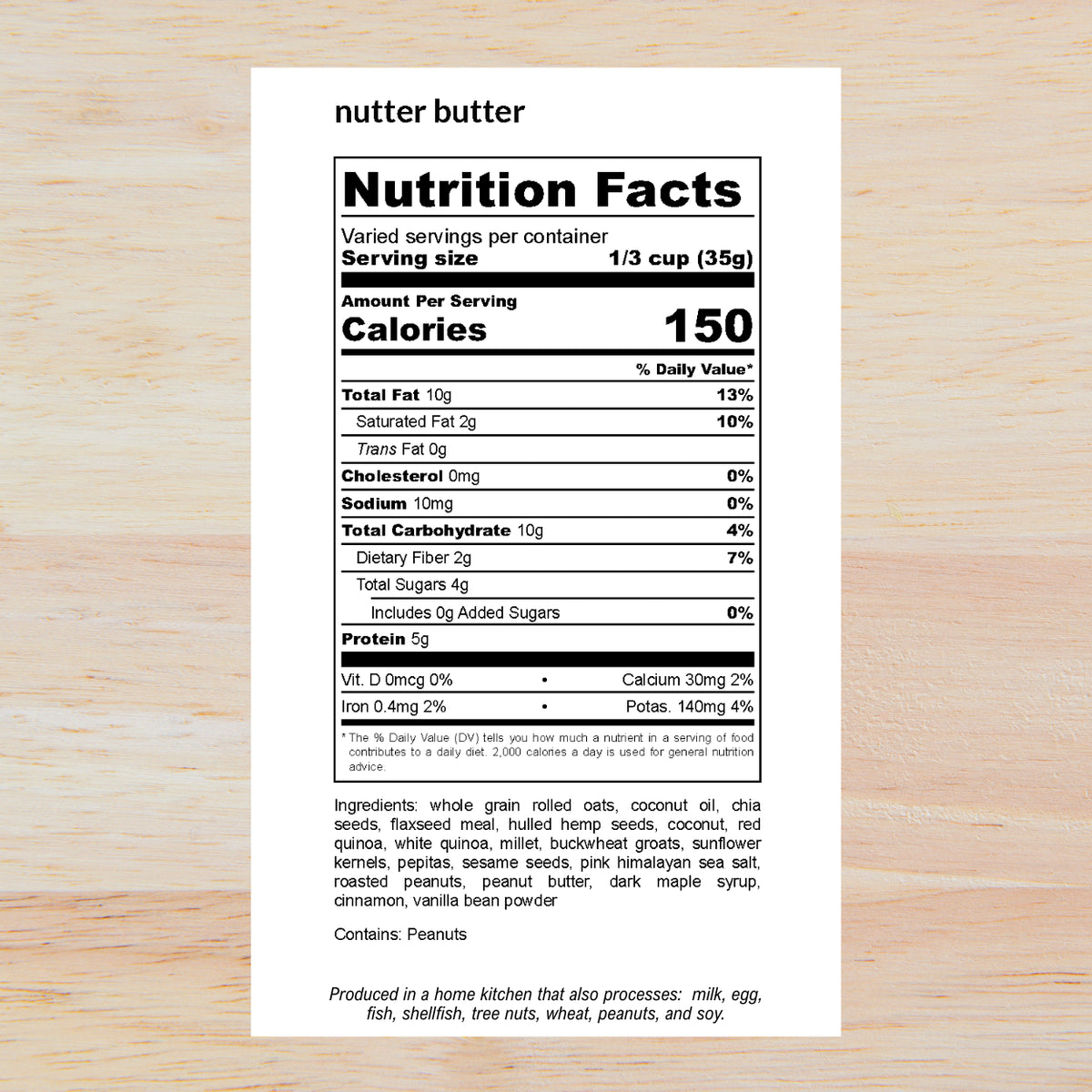 A Nutrition Facts label for nutter butter shown on a light wood background. The label is black and white, detailing calories, fat, protein, and ingredients for a serving size of 1/3 cup (35g).