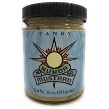 Jar of tangy mustard with a blue label and black lid.